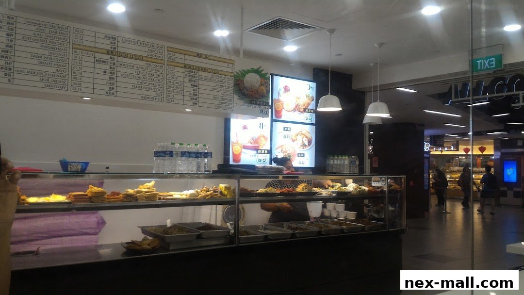 A food stall with a display of various dishes and a menu board above.