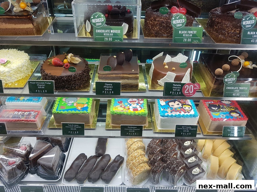 A display case filled with various cakes and pastries from Polar Puffs & Cakes.