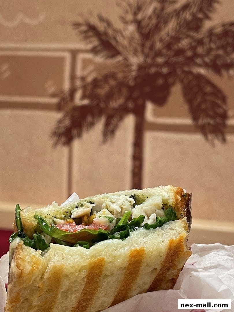 A close-up of a delicious sandwich with fresh ingredients and grilled bread.