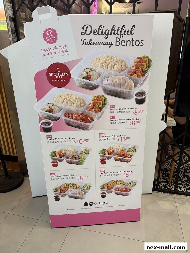 A display board showcasing various takeaway bento boxes from Go-Ang Pratunam Chicken Rice.