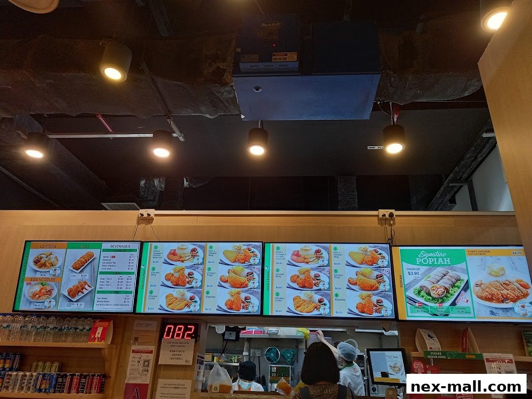 Digital menu boards displaying food items and prices at Qi Ji restaurant.