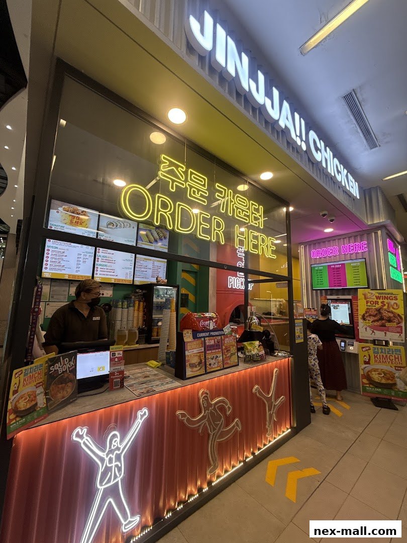 The JINJJA Chicken shop front with an ordering counter and menu displays.