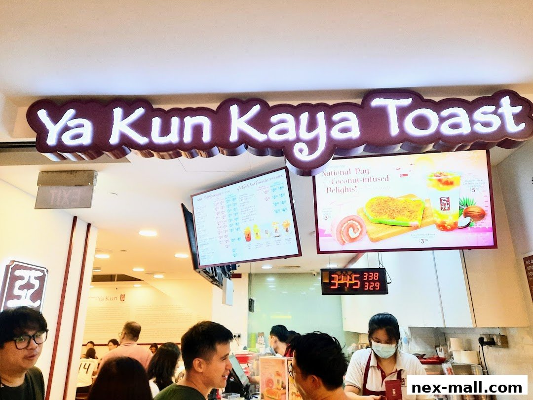 A view of the Ya Kun Kaya Toast shop interior with a menu board and customers.