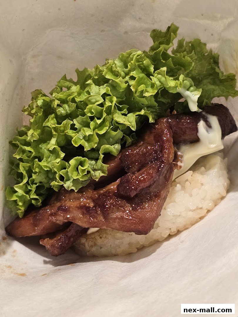 A close-up of a delicious MOS Burger rice burger with grilled chicken, lettuce, and cheese.