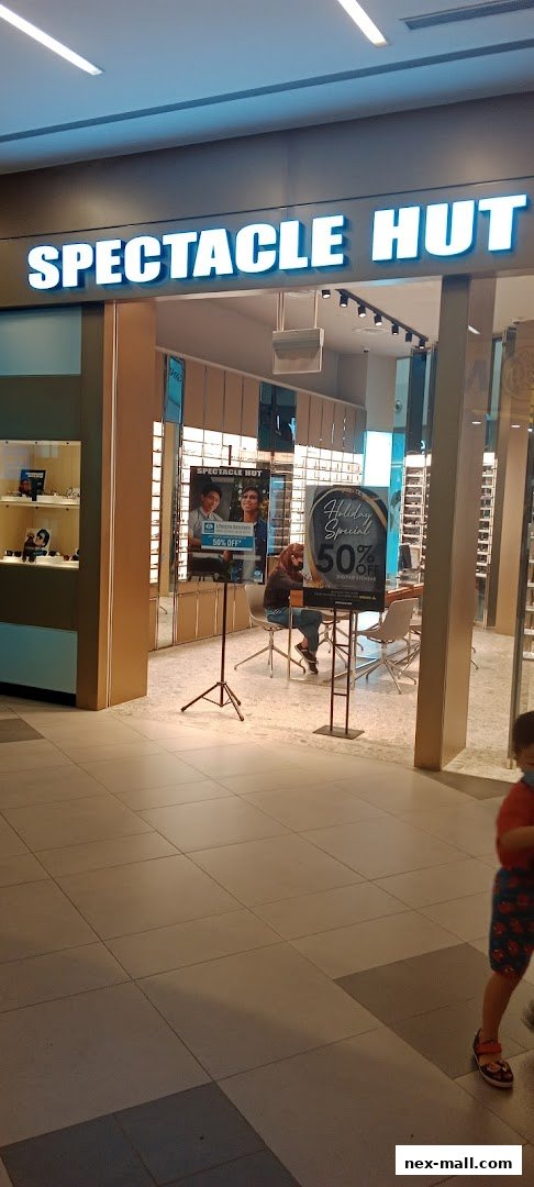 The entrance to Spectacle Hut, an optical shop, with a holiday special offer displayed.