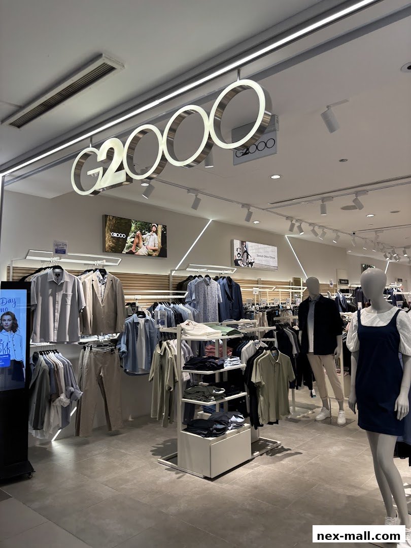 Interior view of a G2000 clothing store showcasing men's and women's apparel on racks and mannequins.