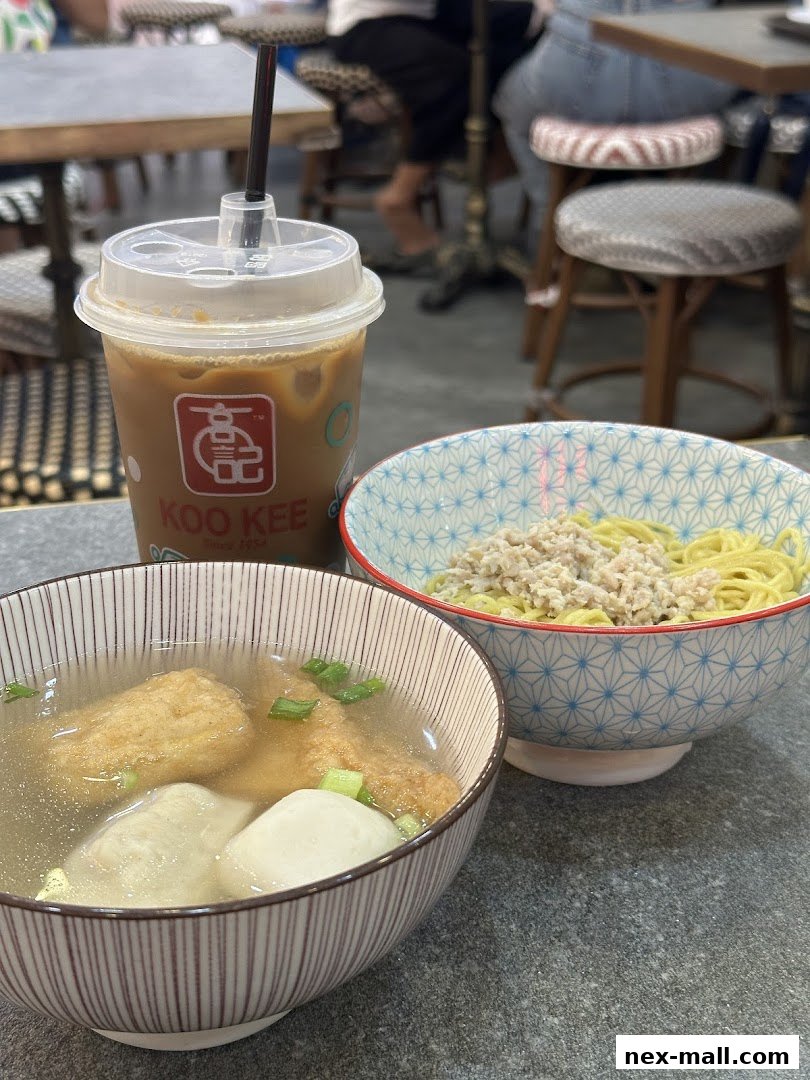 A close-up of two bowls of food and a drink from Koo Kee.