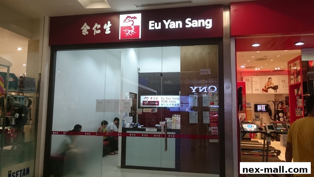 The entrance of Eu Yan Sang TCM Clinic with a reception area and waiting customers.