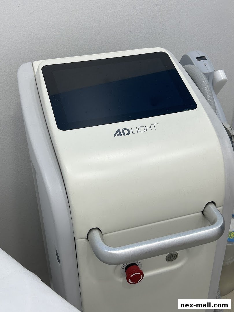 Close-up of a white IPL hair removal machine with a touchscreen and handle.