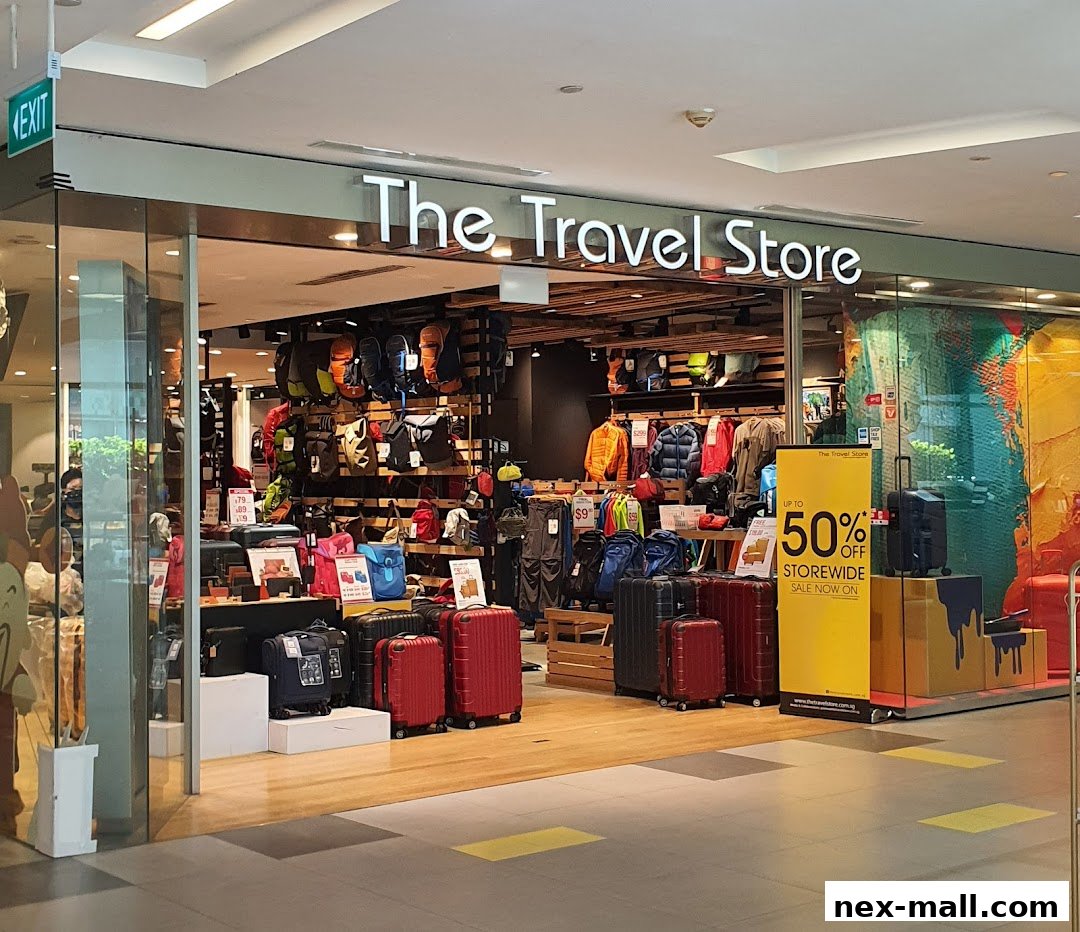 The Travel Store entrance showcasing luggage, backpacks, and apparel with a 50% off sale banner.