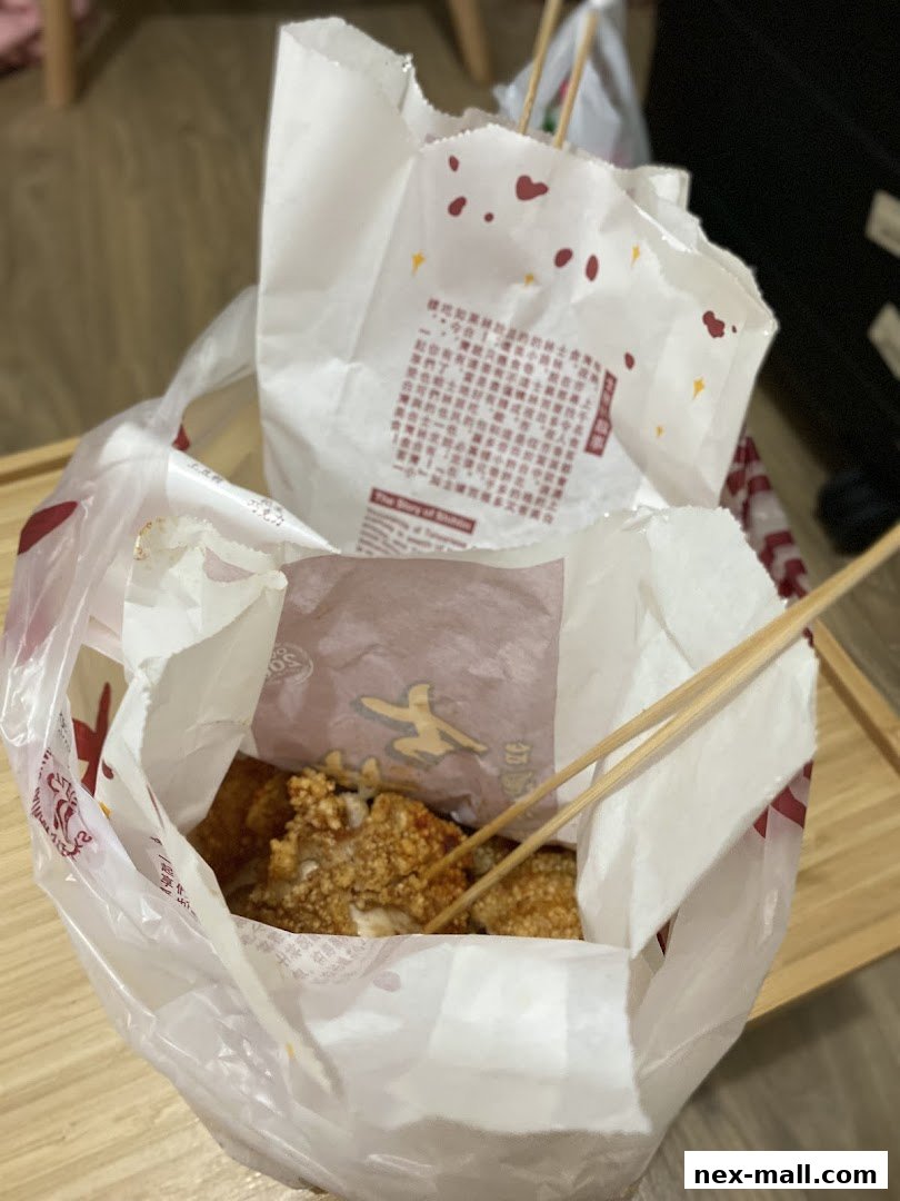 A bag filled with delicious Taiwanese fried chicken and chopsticks.
