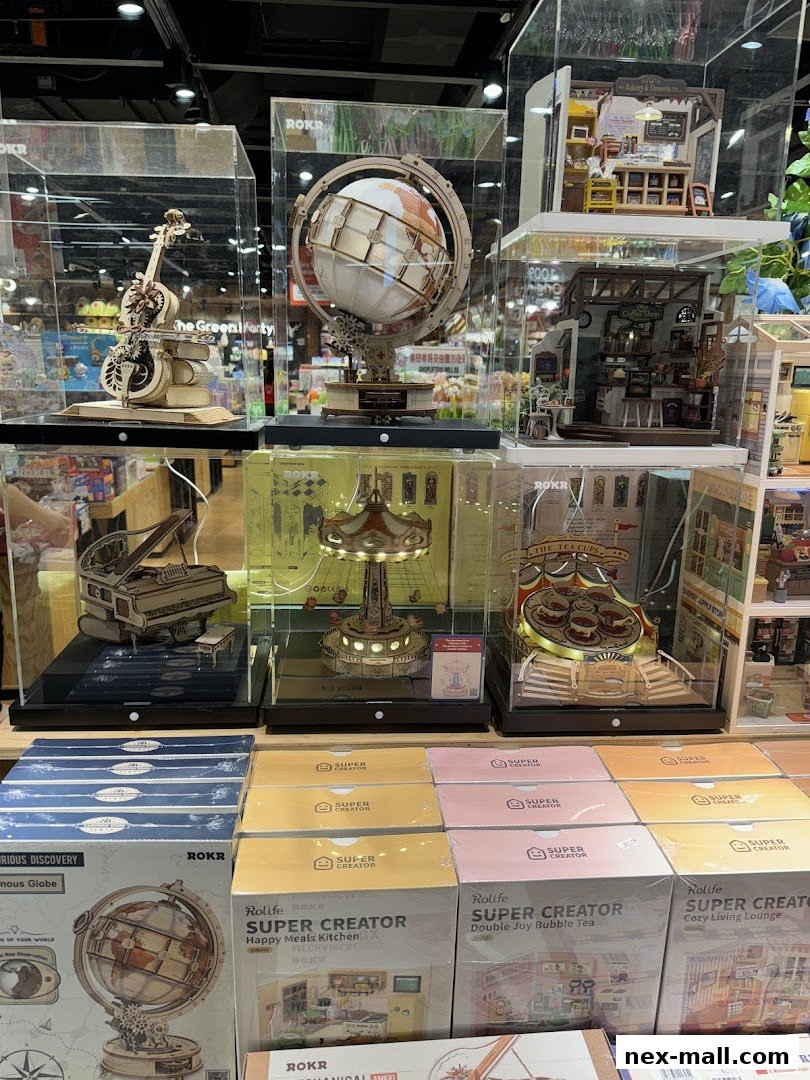 A display of intricate ROKR and Rolife DIY miniature models, including a globe, violin, and carousel.