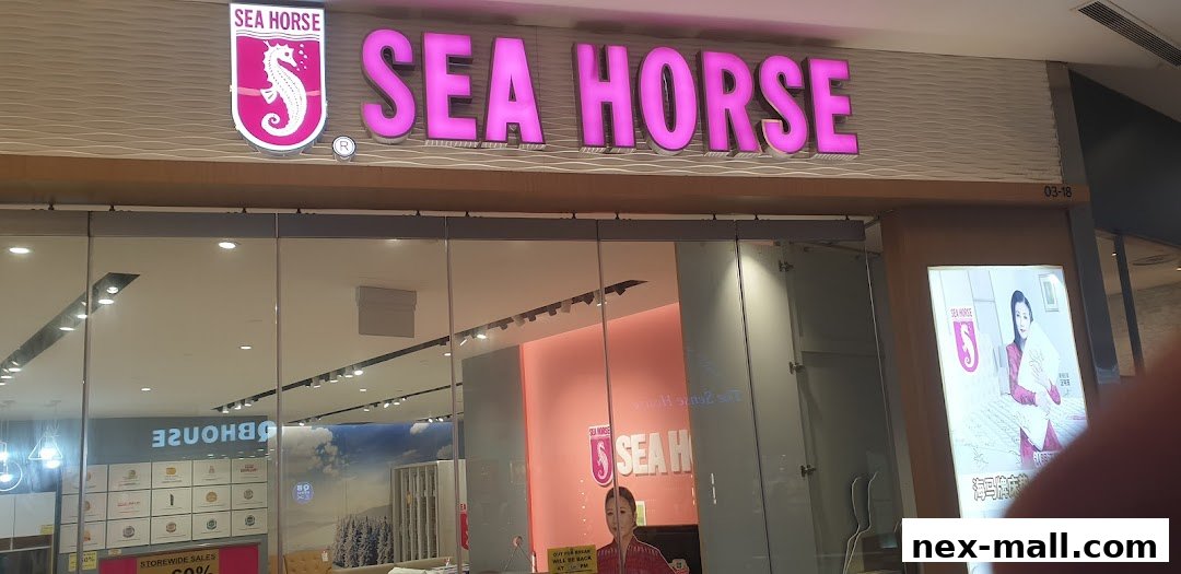 The Sea Horse store front with its prominent pink logo and illuminated signage.