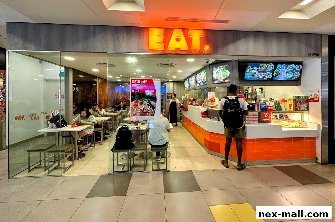 The EAT. shop front with customers dining inside and ordering at the counter.