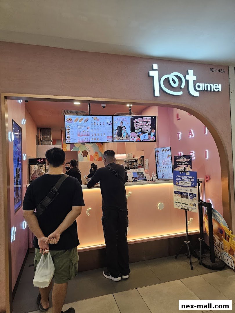 The entrance of the "I Love Taimei" shop with customers ordering at the counter.