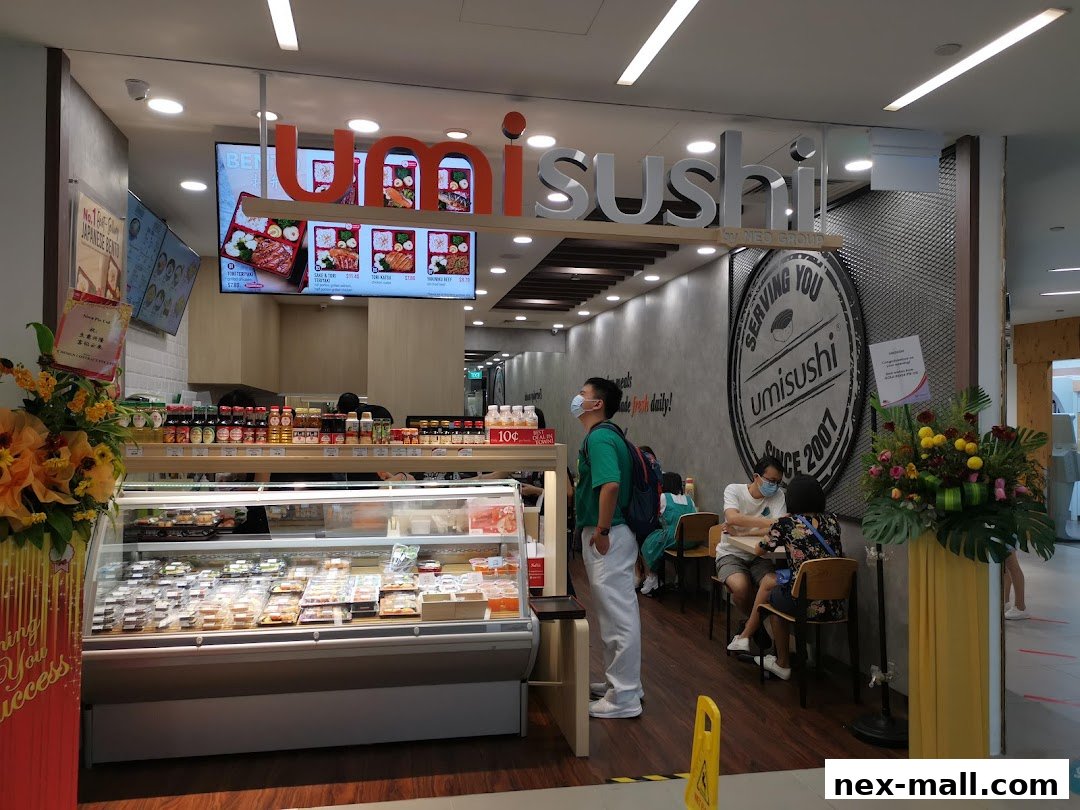 Umisushi NEX shop front with display of sushi and bento boxes, and customers seated inside.