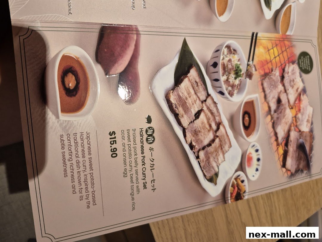 A menu item featuring Hainanese Pork Curry Set with braised pork belly and sweet potato curry.