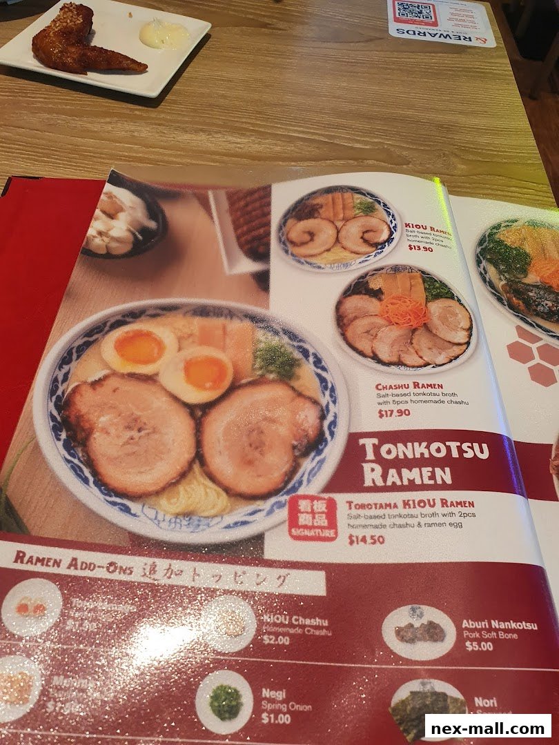 A close-up of a ramen menu featuring Tonkotsu Ramen and various add-ons.