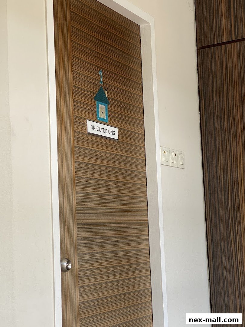 A wooden door with a sign for Dr. Clyde Ong and a small house illustration.