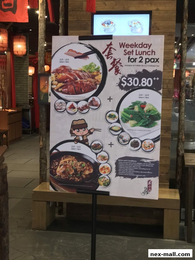 A menu board advertising a weekday set lunch for two people at Dian Xiao Er NEX.