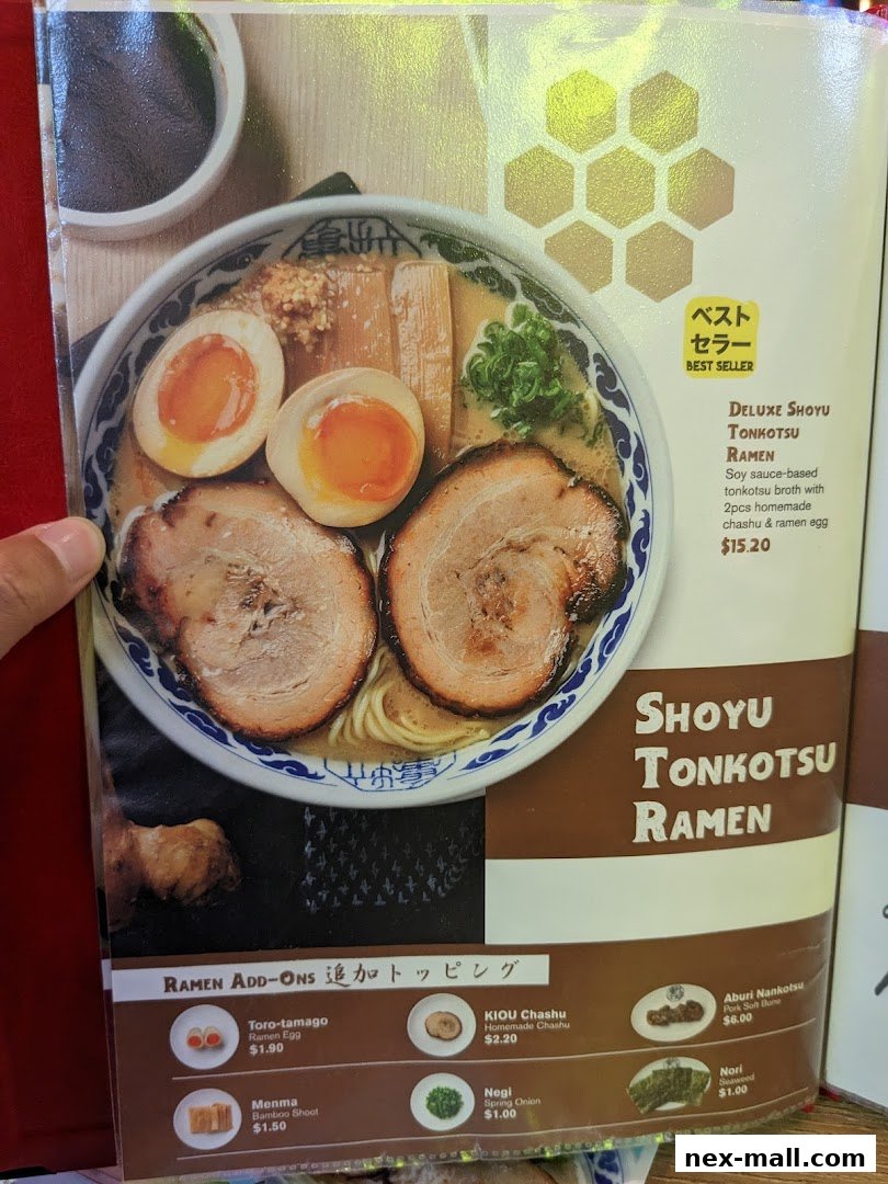 A close-up of a delicious bowl of Shoyu Tonkotsu Ramen with add-on options.