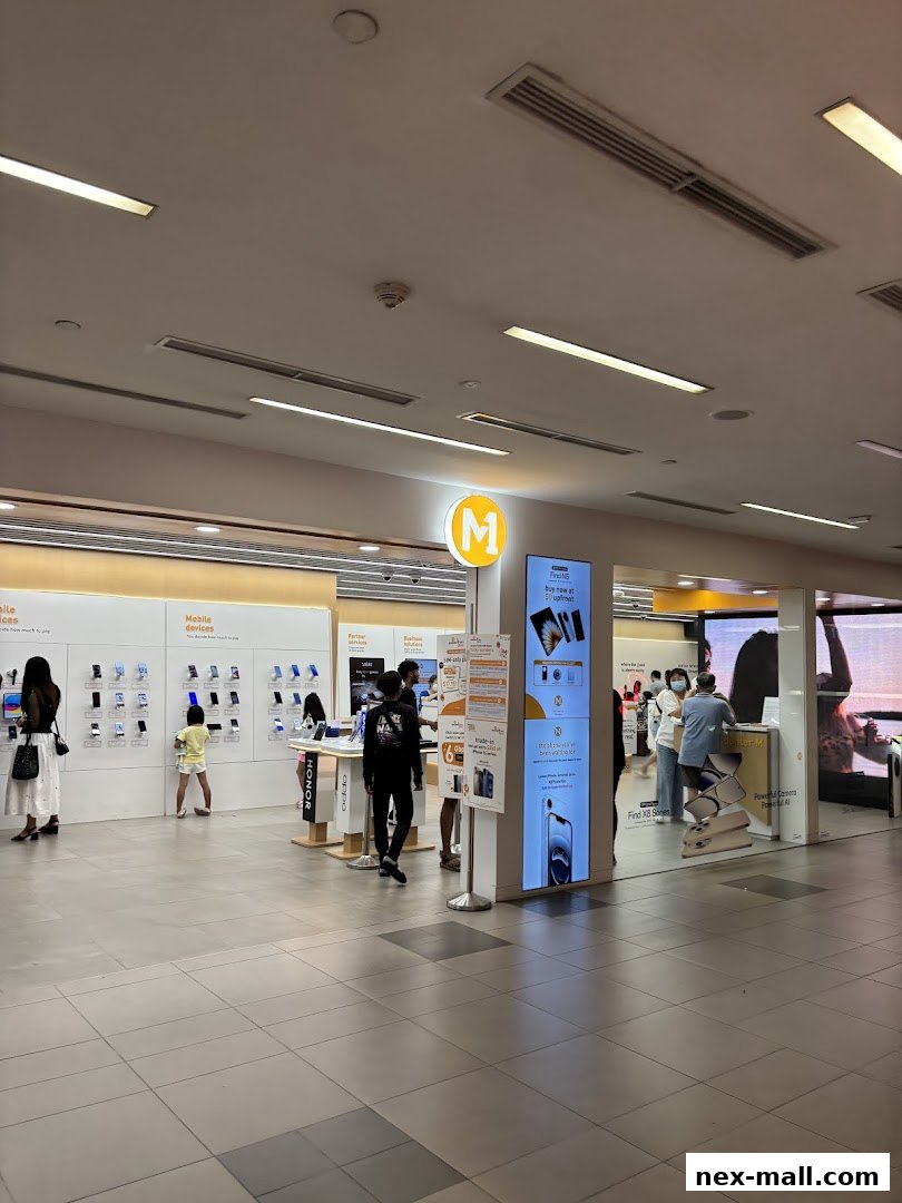 Interior view of a modern mobile phone shop with displays of devices and customers browsing.