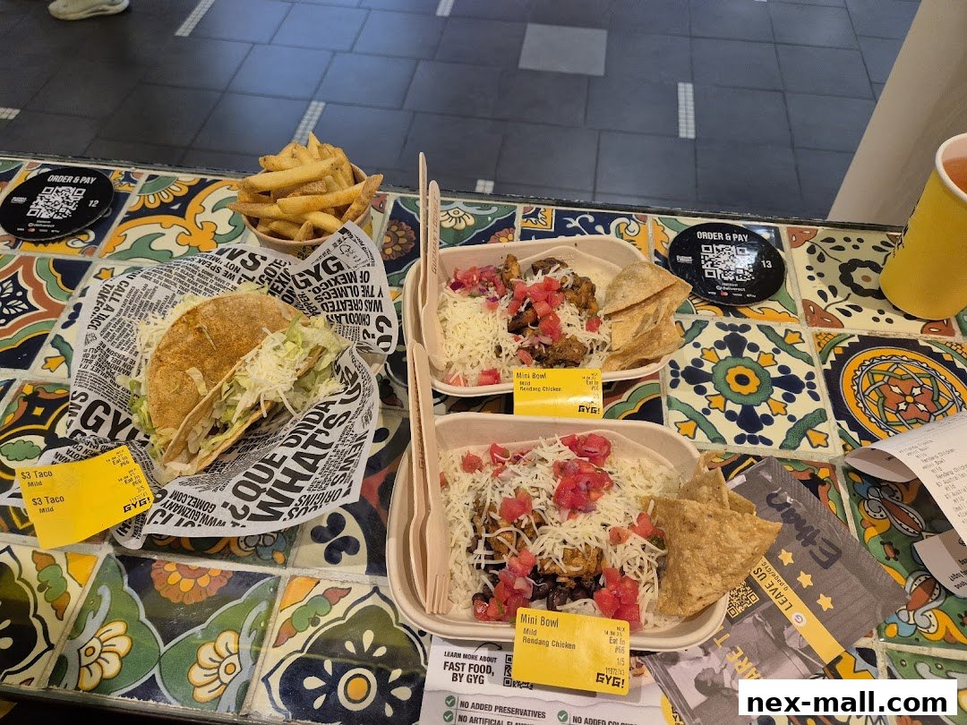 A table displaying Guzman y Gomez tacos, mini bowls, and fries.