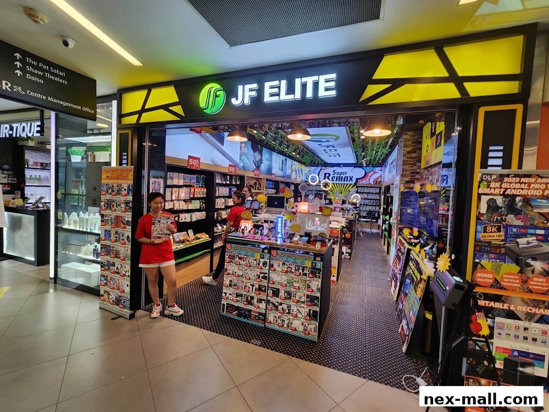 A well-lit electronics store with a wide selection of gadgets and accessories, featuring a prominent "JF Elite" sign.