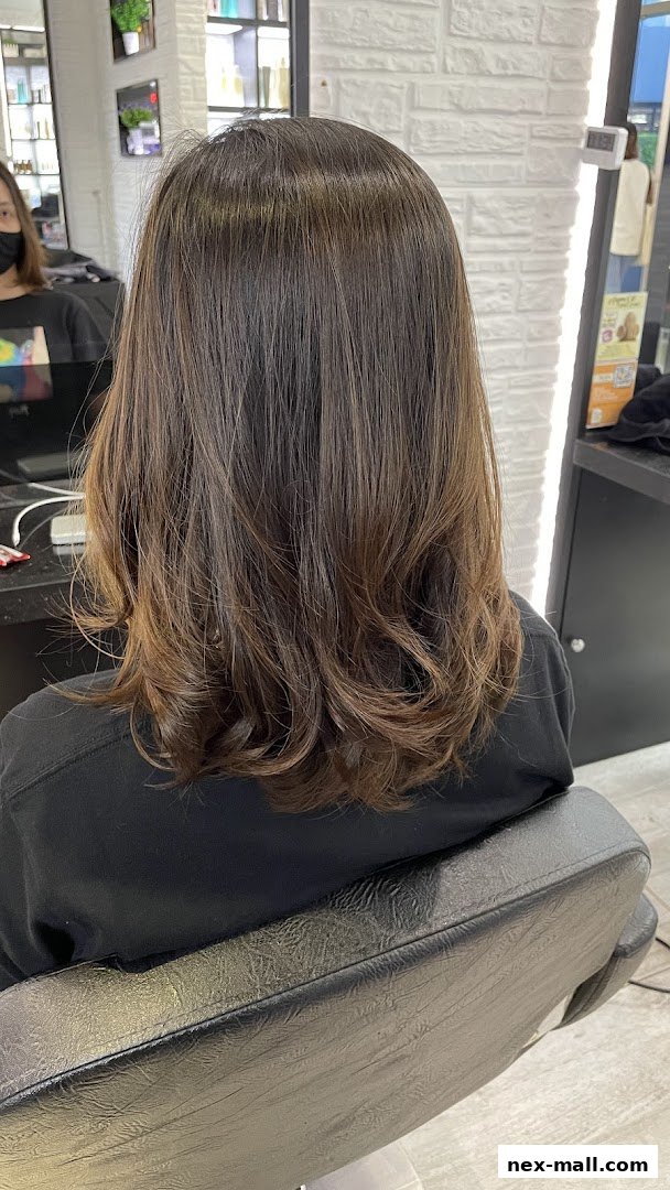 A person's back with freshly styled, layered brown hair with subtle highlights.