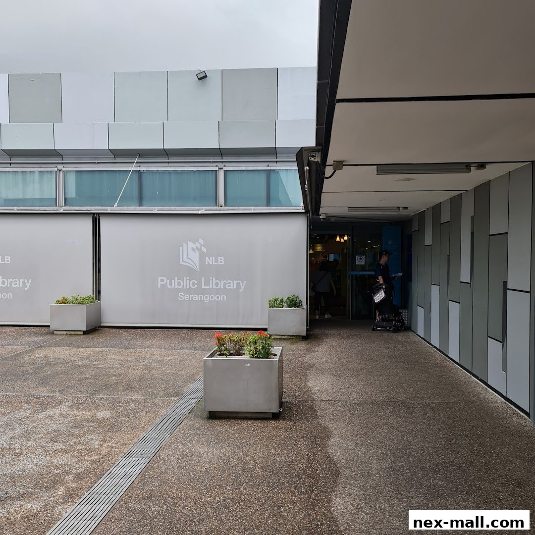 The entrance to Serangoon Public Library with its signage and planters.