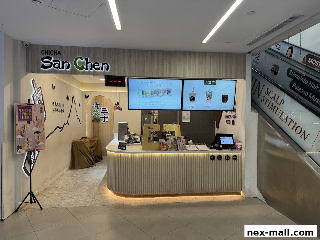 The CHICHA San Chen bubble tea shop counter with digital menus and a promotional stand.
