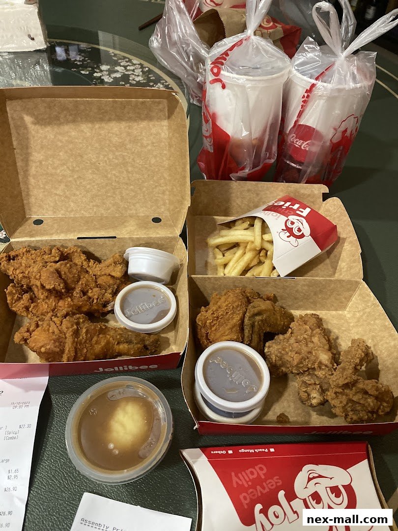 A spread of Jollibee fried chicken meals, fries, and drinks, ready for enjoyment.