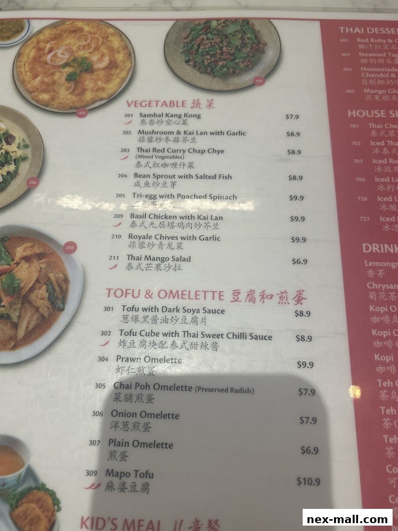 A menu from Go-Ang Pratunam Chicken Rice featuring Thai dishes like vegetables, tofu, and omelettes.