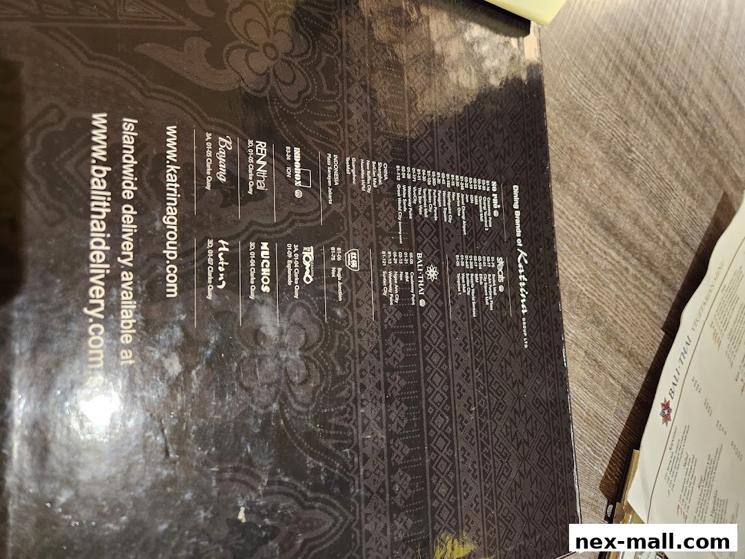A dark-colored brochure or menu listing various dining brands and their locations.
