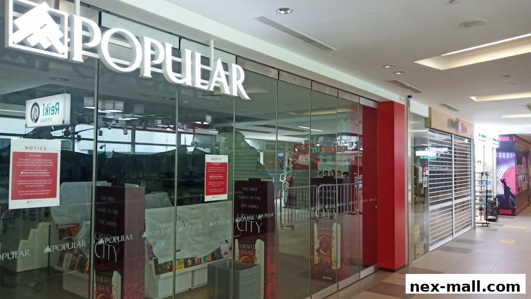 The exterior of a POPULAR Bookstore with large glass windows displaying books and promotional materials.