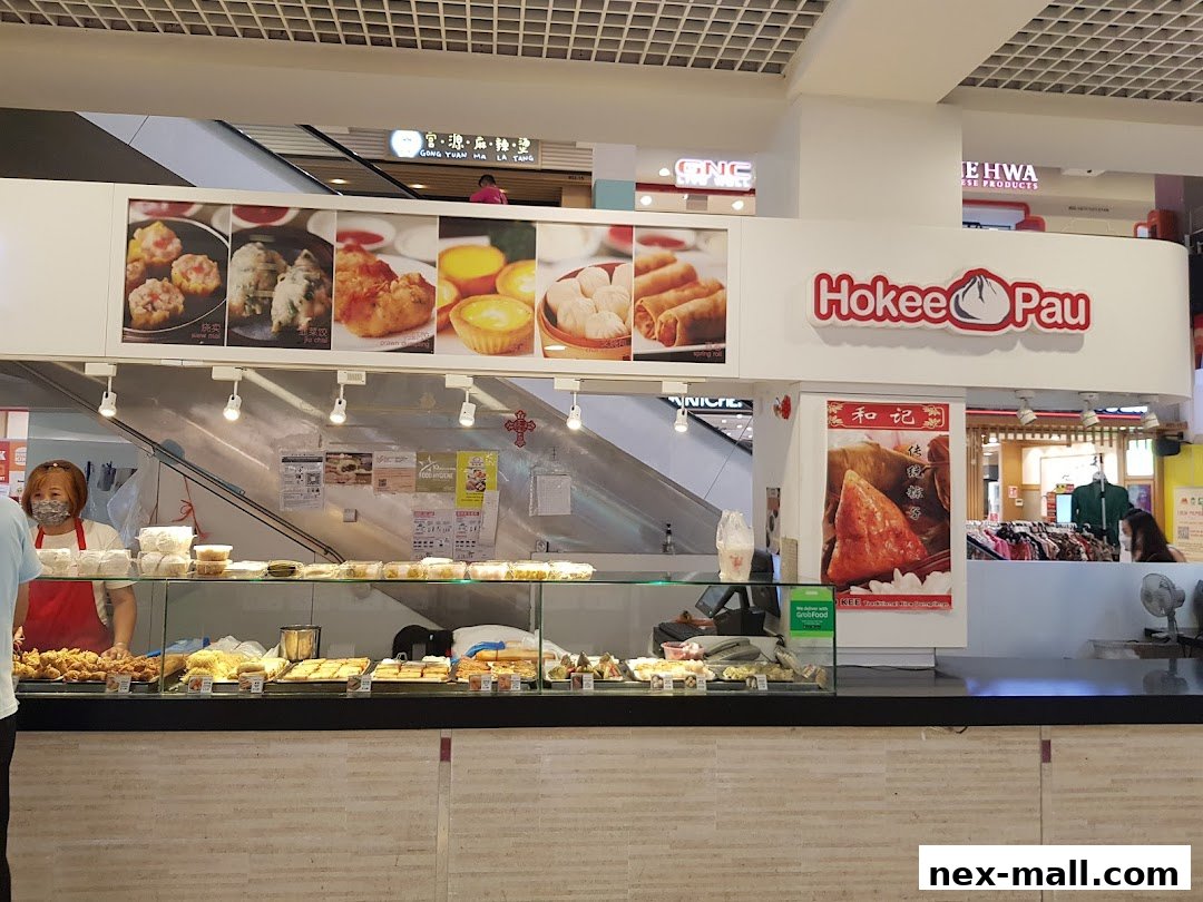 A Ho Kee Pau shop with a display of various food items and a staff member behind the counter.