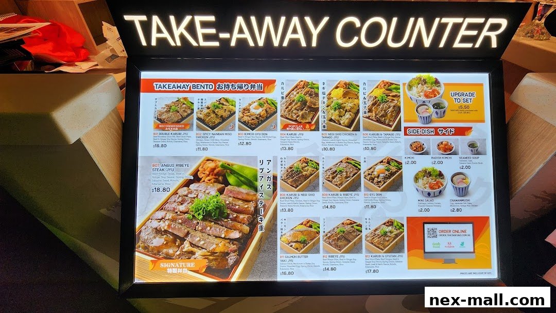 A menu board displaying various Japanese bento boxes and side dishes for takeaway.