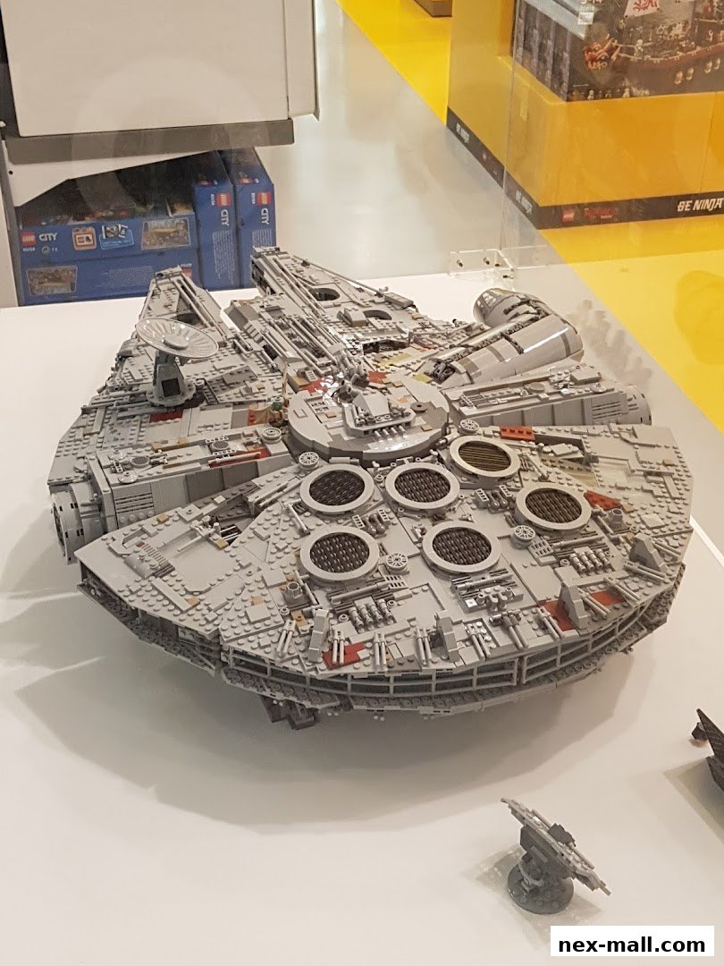 A detailed LEGO Millennium Falcon model displayed in a store.