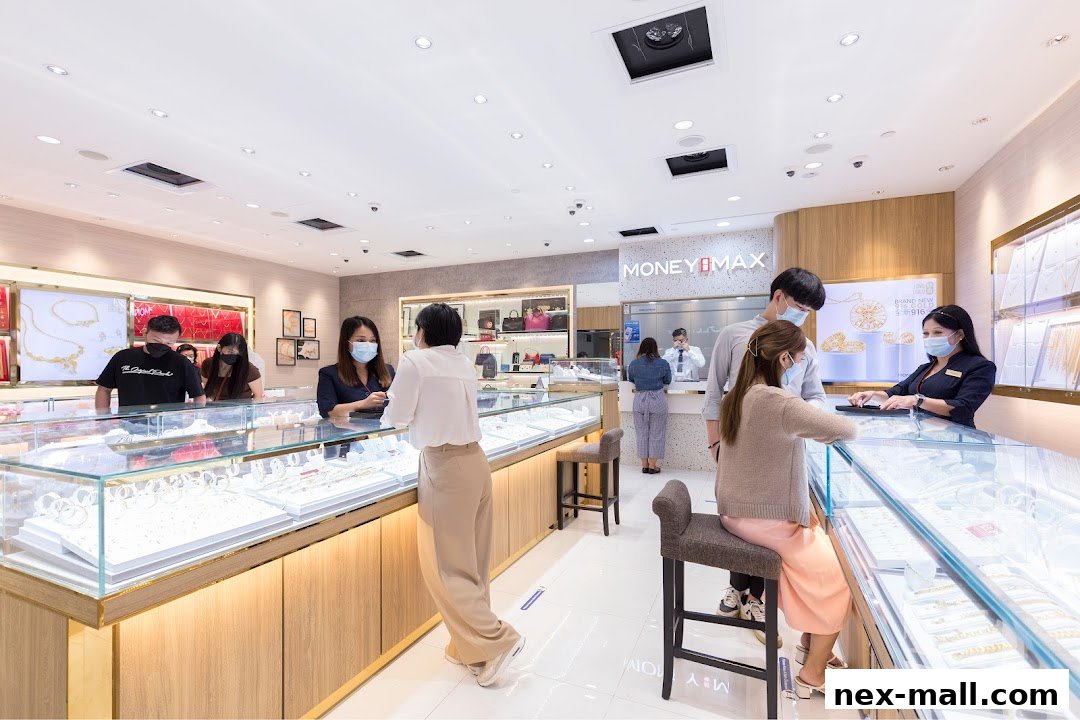 Customers interacting with staff at MoneyMax Pawnshop, browsing jewelry displays.