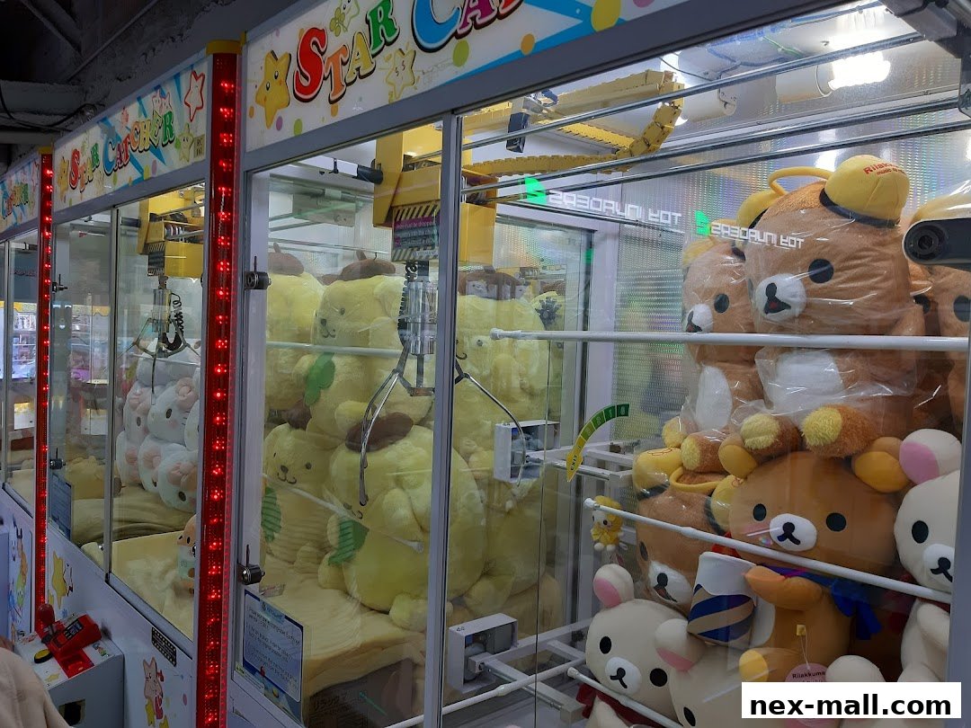 A row of claw machines filled with plush toys, including Rilakkuma and other characters.