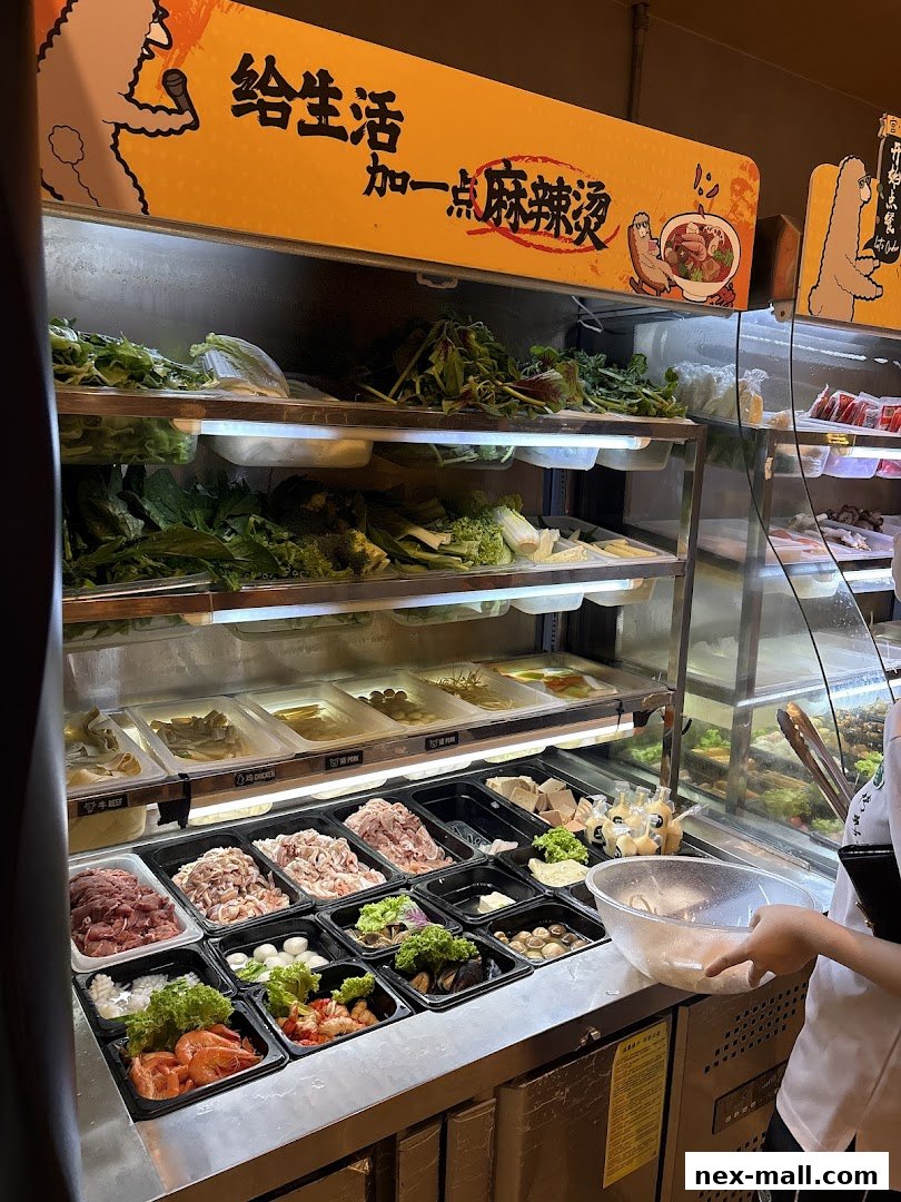 A display of fresh ingredients for Mala Tang, including meats, vegetables, and seafood.