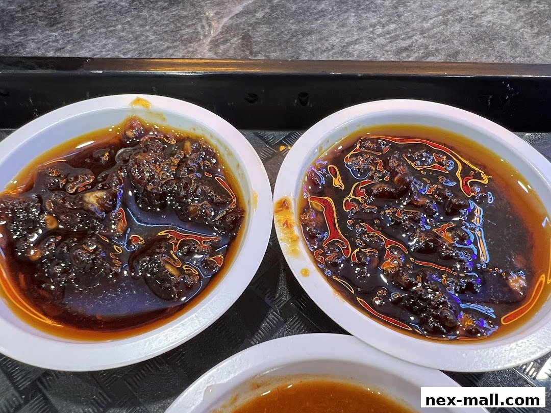 Two white bowls filled with a dark, chunky sauce or condiment.