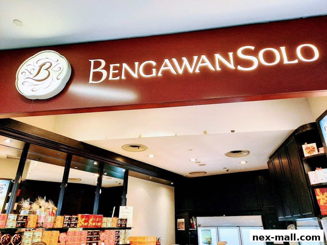 The illuminated sign for Bengawan Solo above a display of packaged goods.
