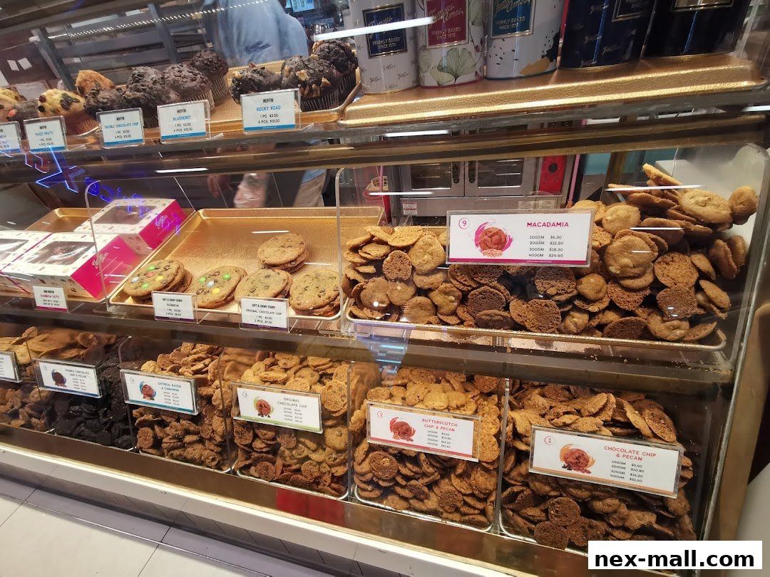 A display case filled with various cookies, muffins, and gift boxes from Famous Amos.