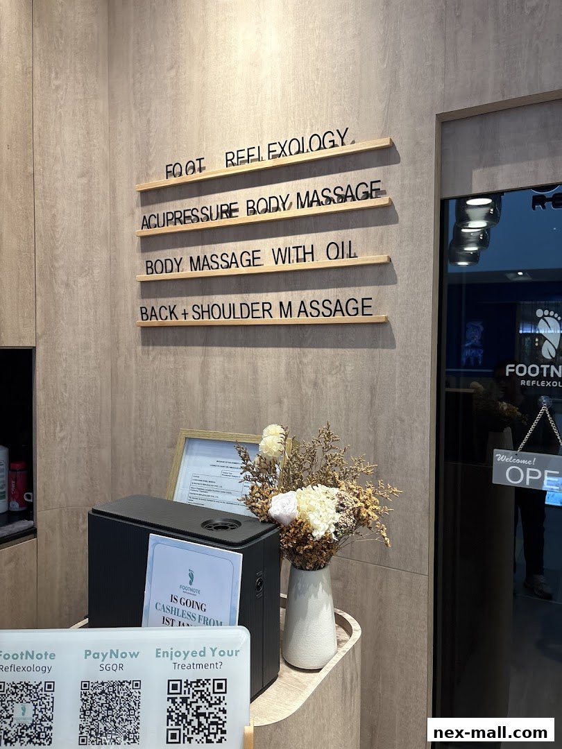 Interior view of FootNote Reflexology showing services offered and payment options.