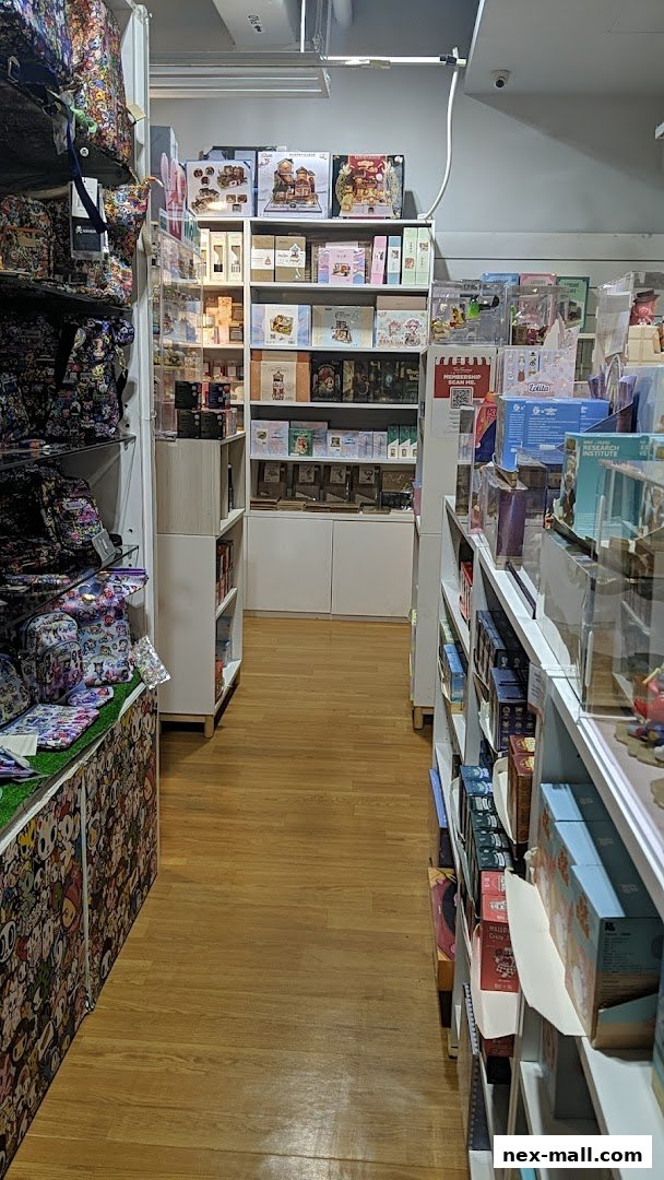 A view down an aisle of a gift shop, showcasing various merchandise on shelves.