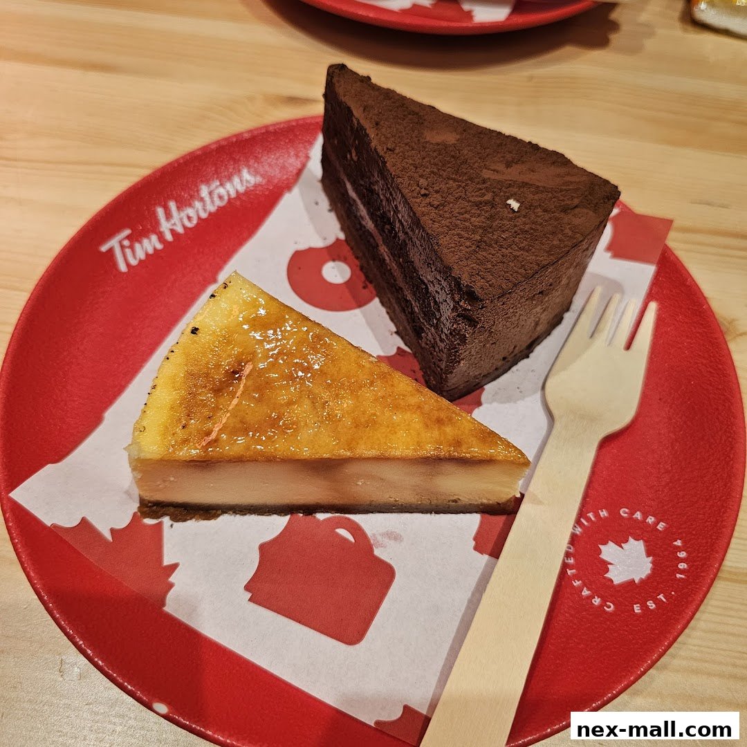 Two slices of cake, one chocolate and one creme brulee, served on a red plate with a fork.