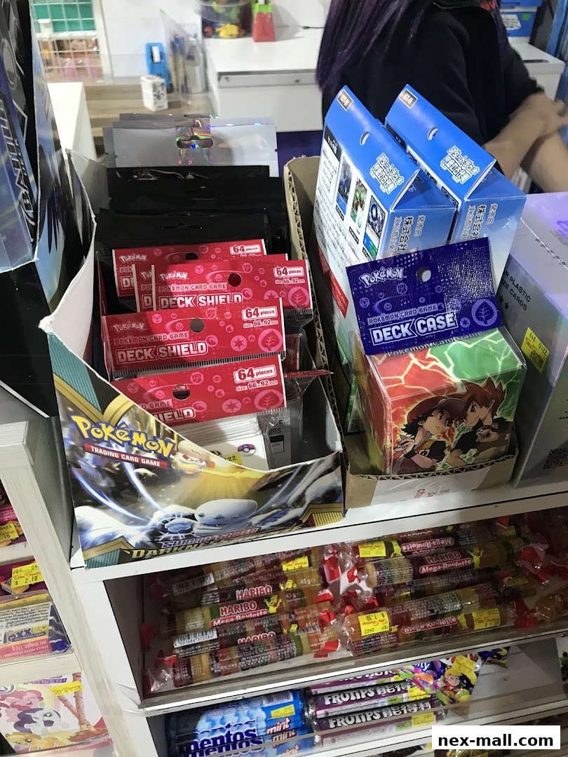 A display of Pokemon trading card game accessories and various candies.