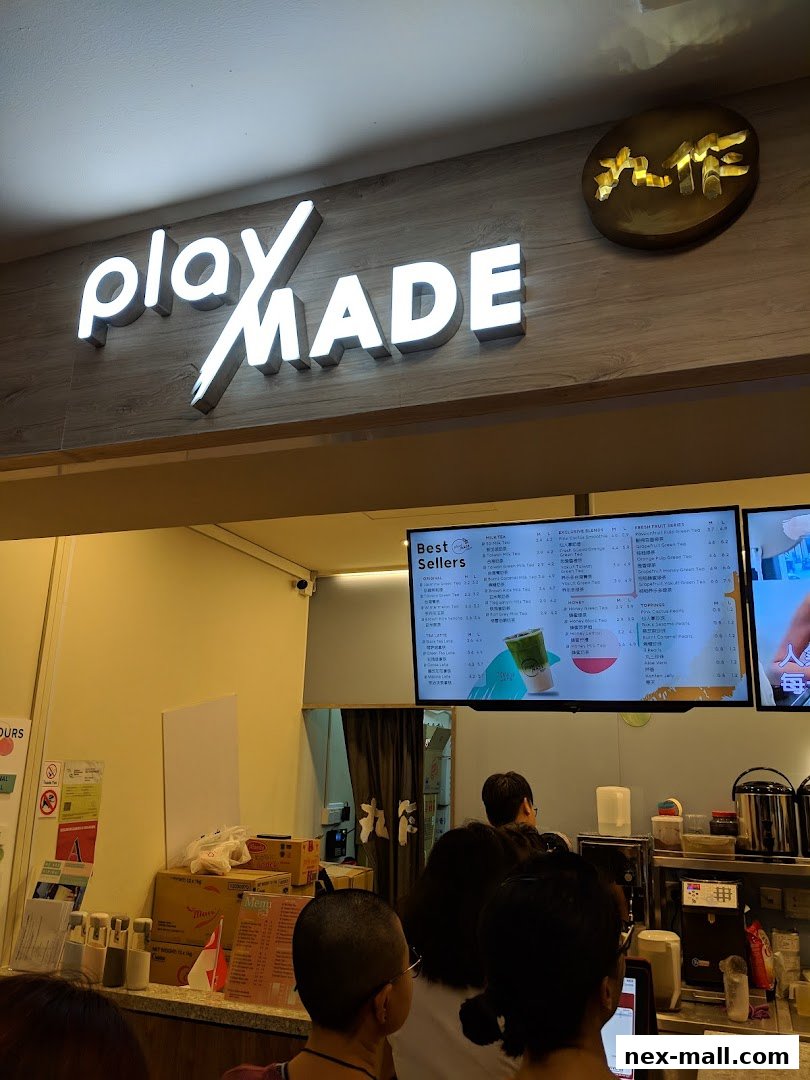 A PlayMade shop with a digital menu displaying best sellers and drinks.