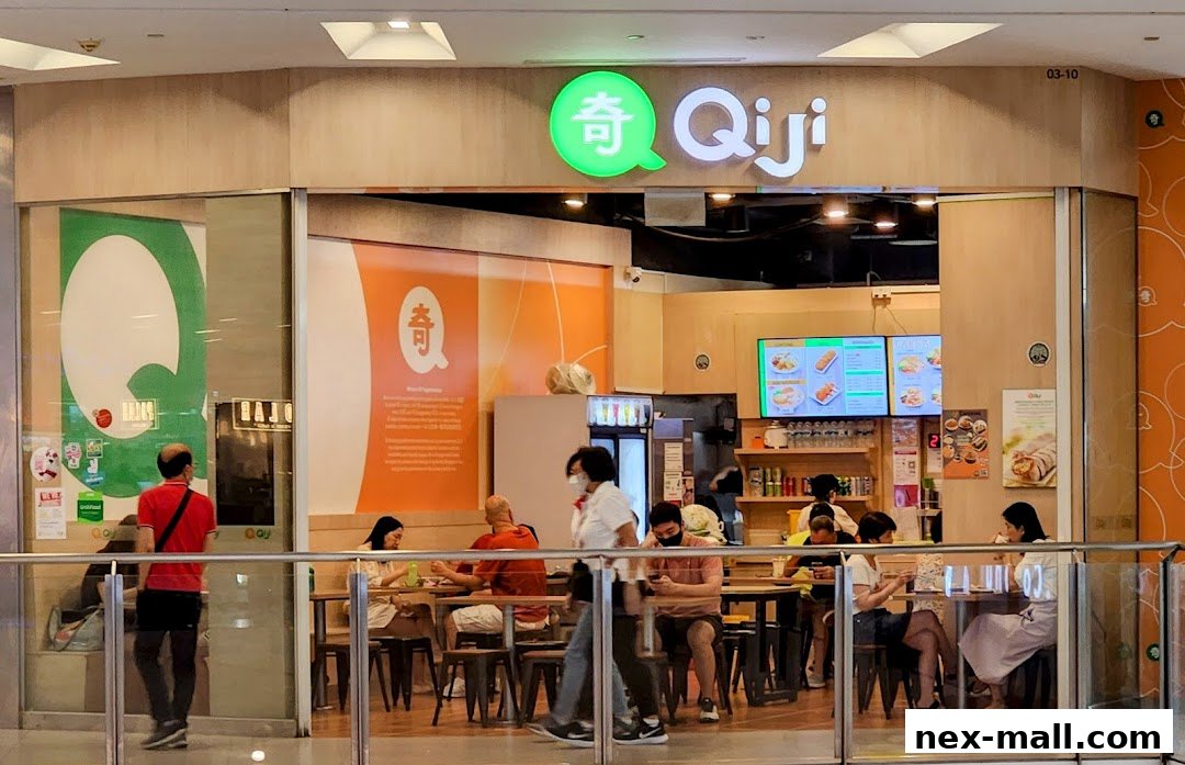 The exterior of the Qi Ji restaurant with customers dining inside.